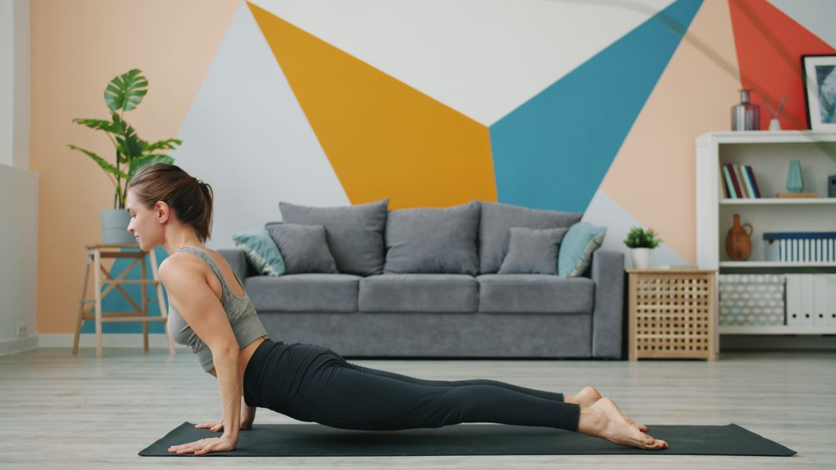Side view of a yoga pose with the whole mat in frame, camera at mat height